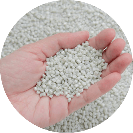 AM Solution's ADFIN resin pellets (Impact Modifier & Compatibilizer) held in a hand to show material texture and size.