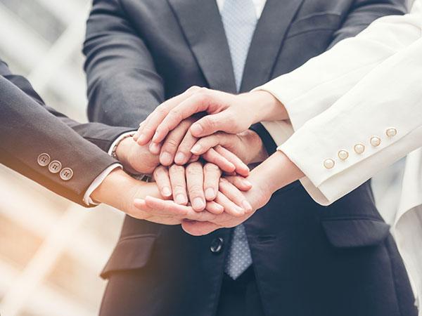 A photo of several people holding hands
